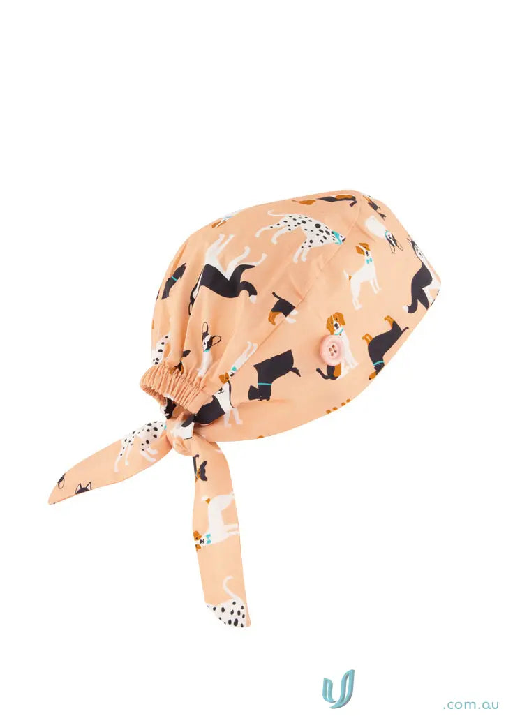 Peach-colored unisex printed scrub cap with cute dog pattern for adding personality