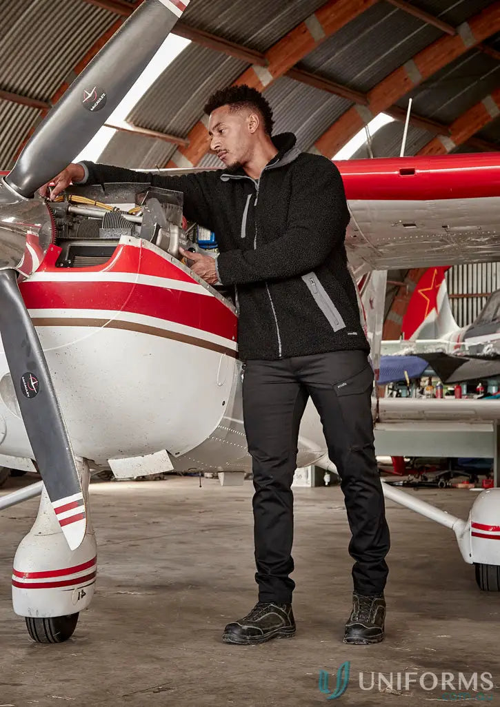 Man in black work pants and fleece zt285 inspecting airplane engine in super warm zip sherpa fleece