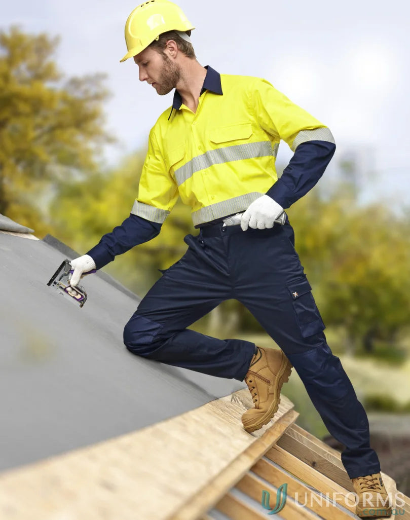 Male construction worker wearing yellow safety shirt and navy stretch cargo work pants