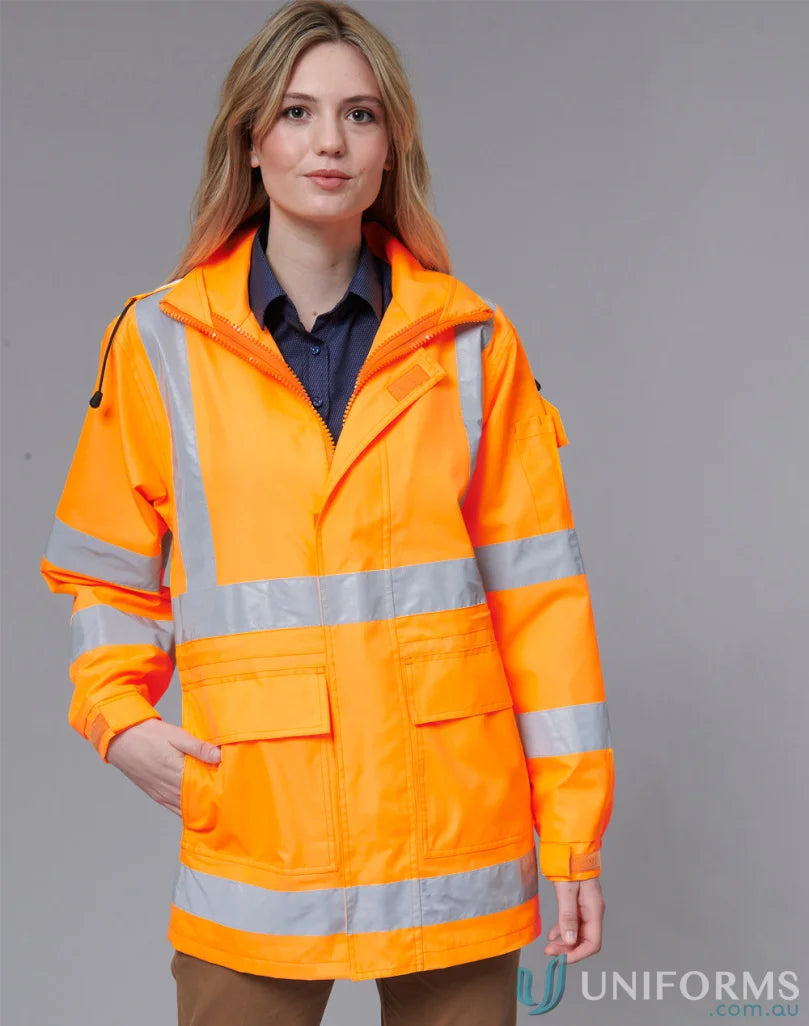 Woman wearing VIC Rail SW75 bright orange waterproof oxford shell safety jacket with bio motion reflective strips
