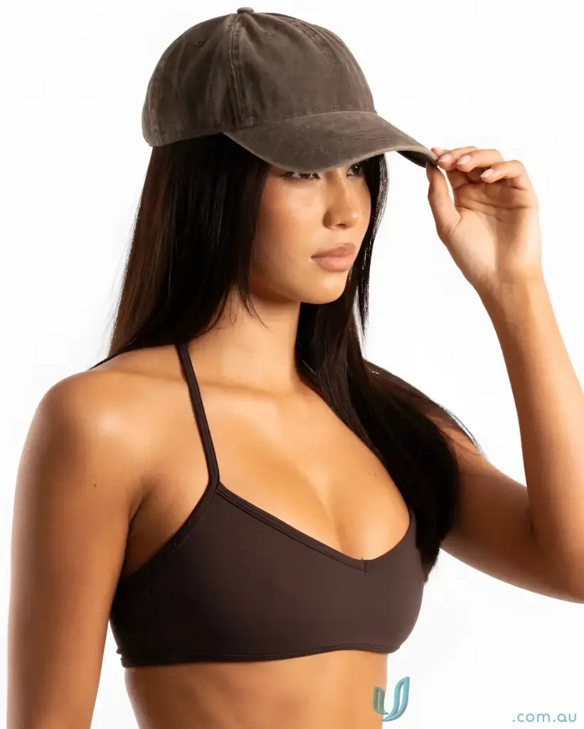 Dark brown distressed vintage washed cap worn by a woman, perfect for casual style