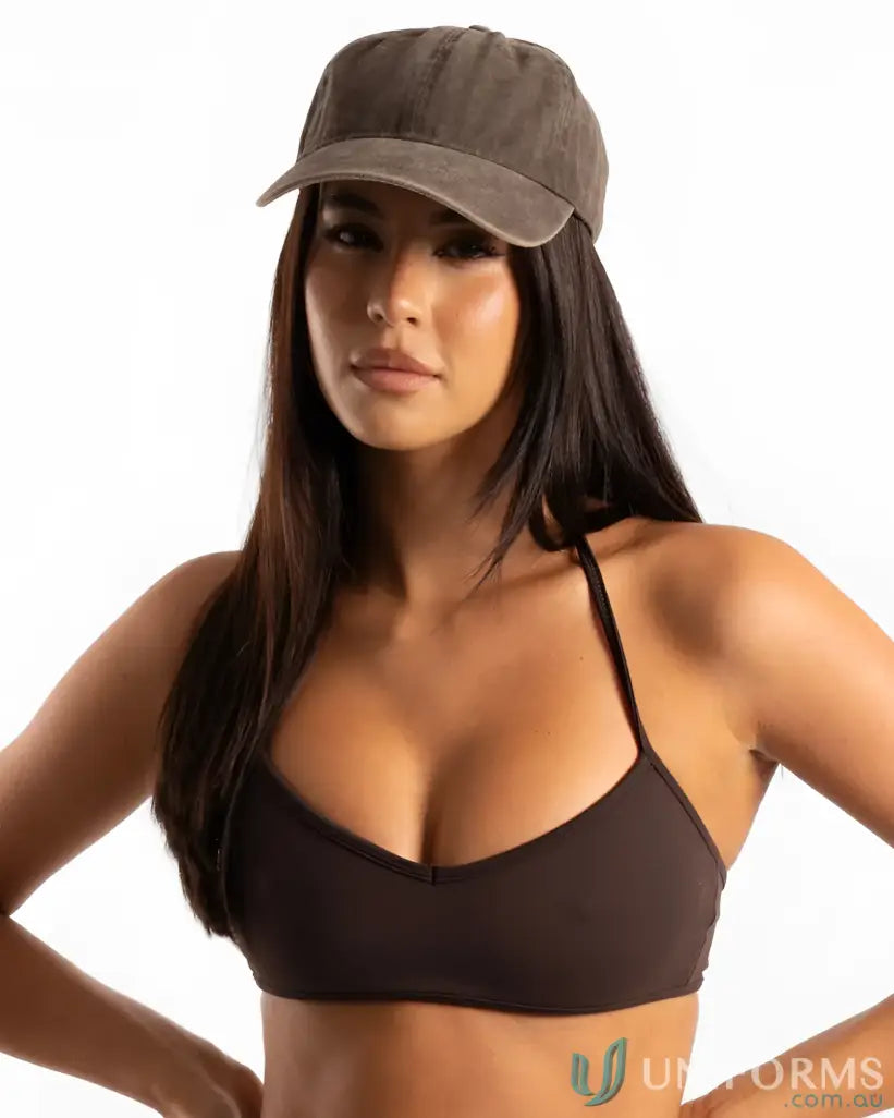 Woman wearing a vintage washed cap and halter bikini top in a stylish vintage look