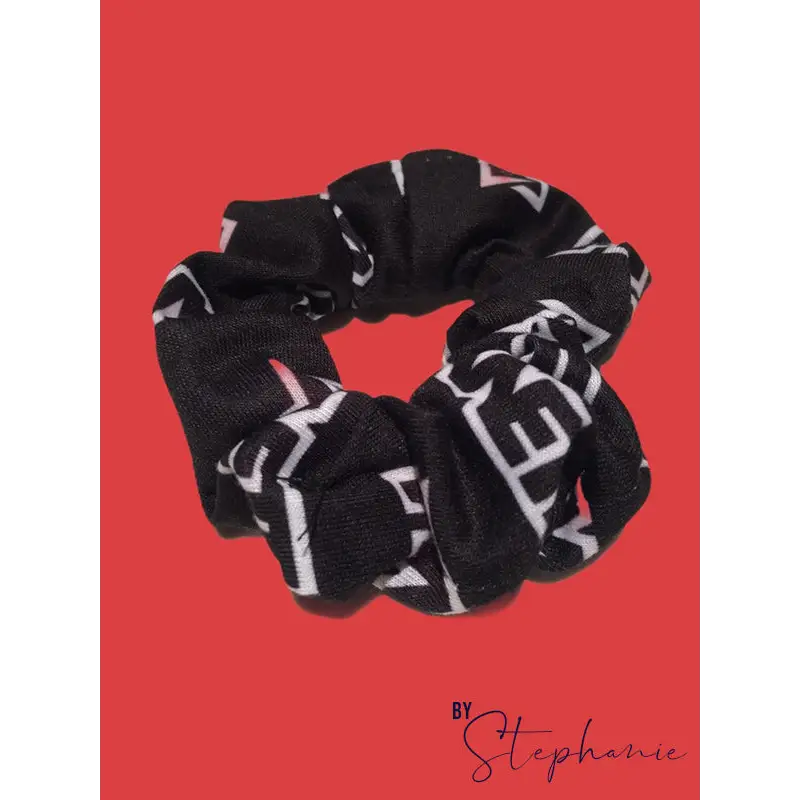 Black scrunchie with bold white geometric lettering perfect for adding style to uniforms and workwear looks
