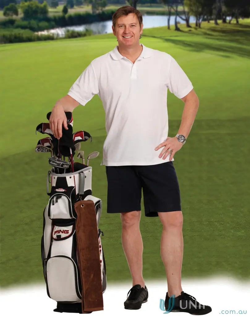 Man in spirit chino shorts standing next to golf bag, great for all-day comfort