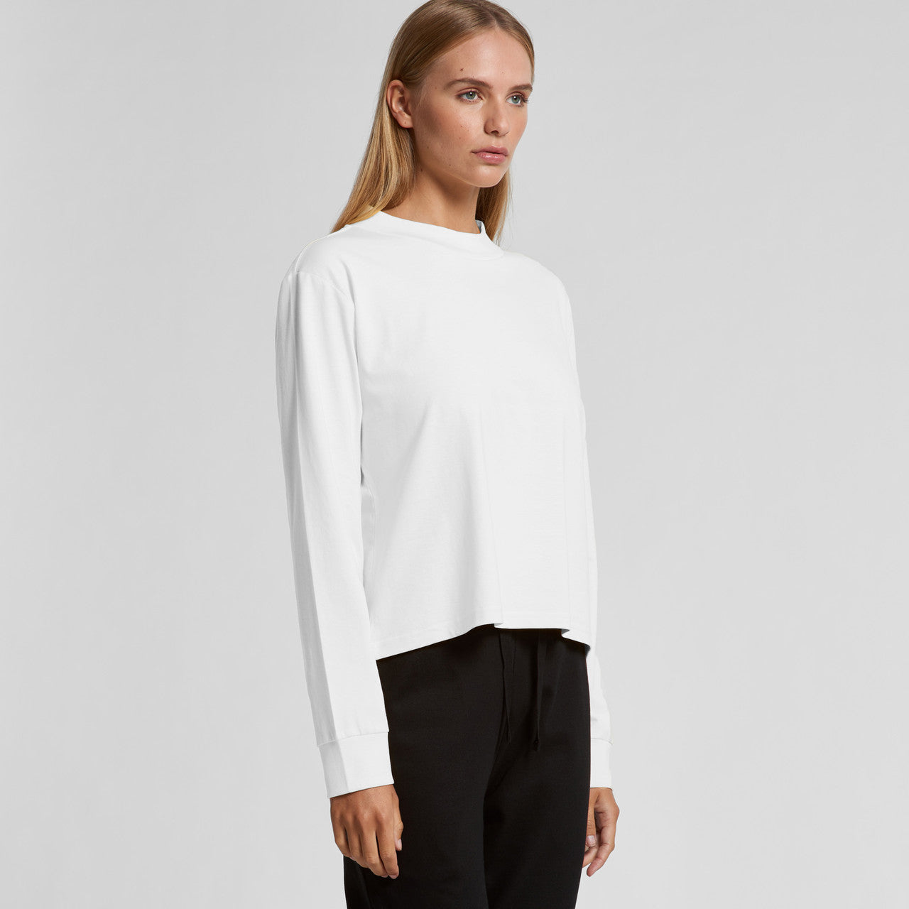 White long-sleeved blouse with a relaxed fit and rounded neckline.