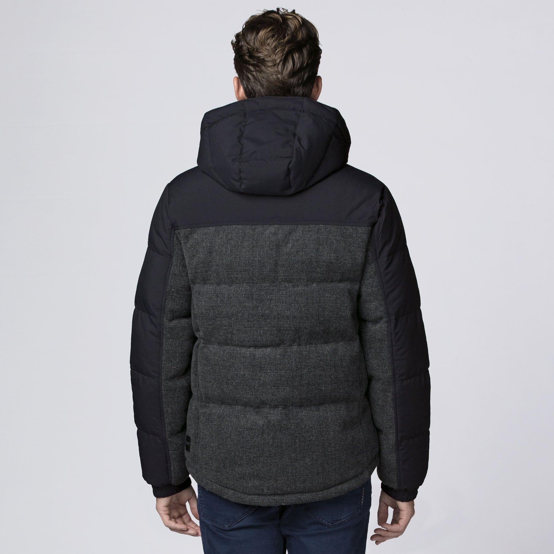 Back view of XT Plunge Jacket: black charcoal gray puffer with quilted back panel