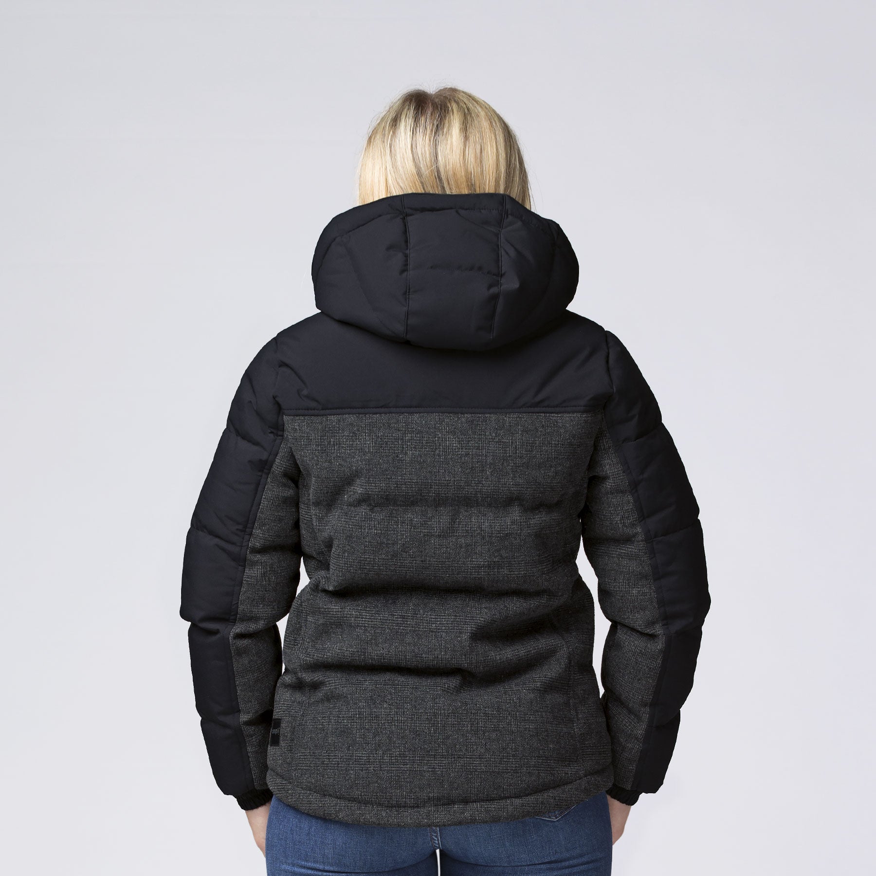 Back view of XT Plunge Jacket: black puffer with charcoal gray quilted panel