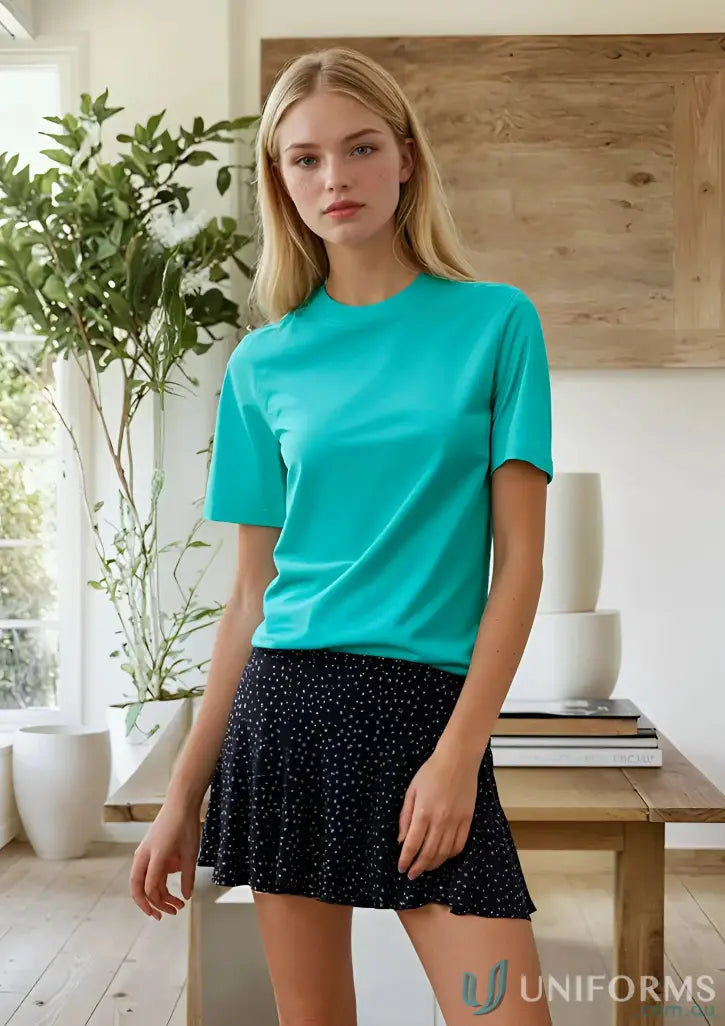 Woman wearing ts37k savvy tee bright teal crew-neck t-shirt and black polka dot mini skirt