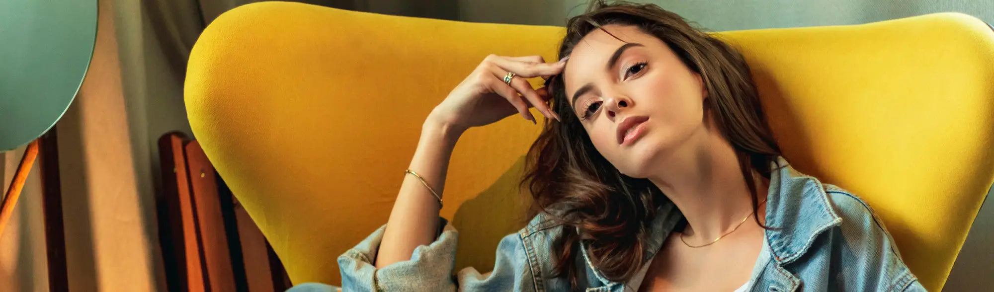 Pensive woman in denim jacket from Planett Women’s Clothing collection, perfect casual workwear