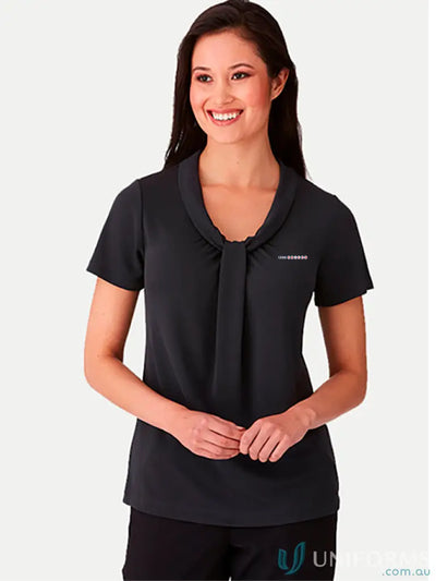 Woman wearing 1300 Receptionist Ladies Top with soft draped neckline and short sleeve style