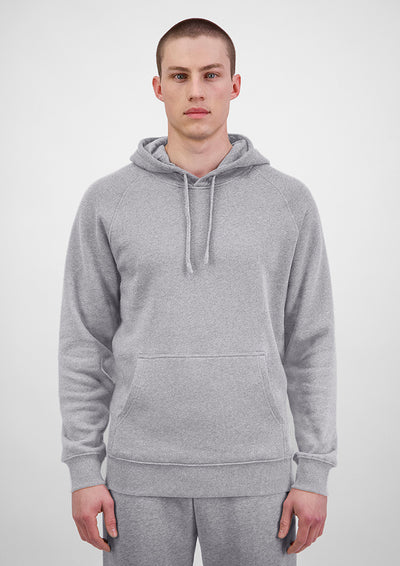Person wearing a gray hoodie on a white background