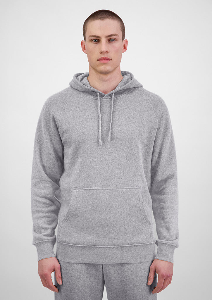 Person wearing a gray hoodie on a white background