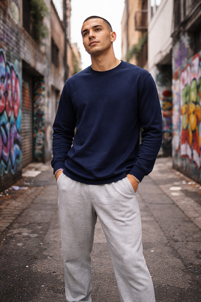 Kids long sleeve tee in navy blue crewneck sweatshirt worn with light gray joggers for comfortable workwear uniforms