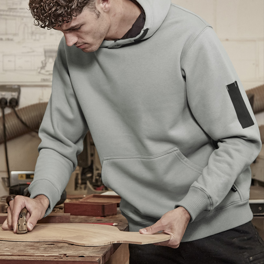 A light gray syzmik multi-pocket hoodie with a black sleeve patch and ribbed cuffs designed for workwear uniforms