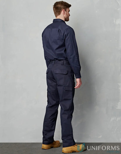 Man in navy blue AIW heavy cotton pre-shrunk drill stout pants and work boots