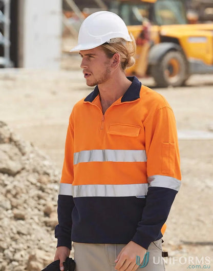 Man in orange navy fleece sweat jumper with reflective tapes and white hard hat