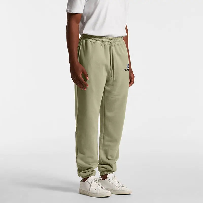 Alien Track Pant: olive green joggers with elastic waist, drawstring, white sneakers