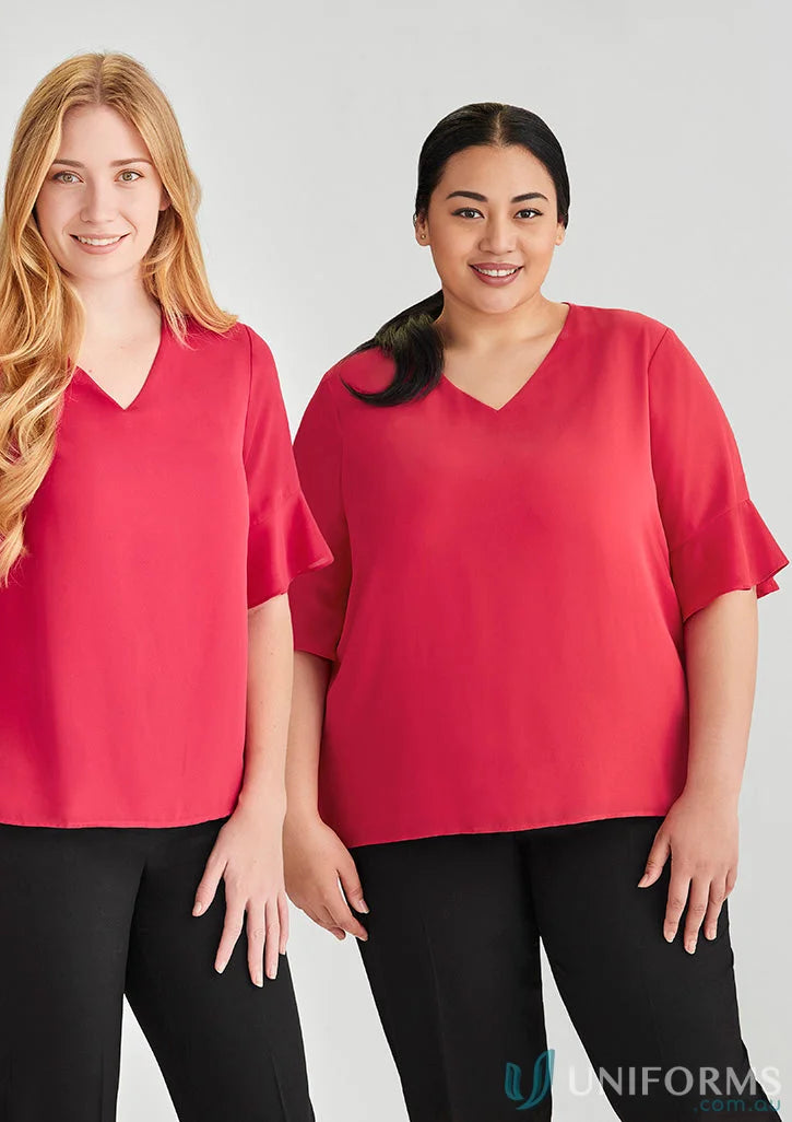 Two women in red Aria Fluted Blouses and black pants, a stylish fluted sleeve workwear option