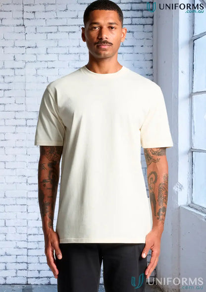 Man wearing a cream-colored AS Classic Tee, a relaxed fit combed cotton tee
