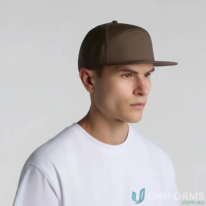 Man wearing AS Colour 1184 flat peak brown cap with plastic snapback and tonal lining