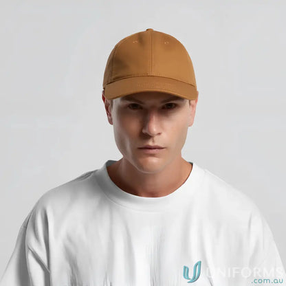 Man wearing a solid brown cotton canvas Access Canvas Cap with adjustable fit