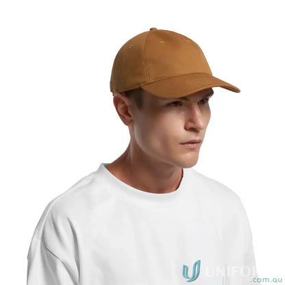 Man wearing a white t-shirt and brown Access Canvas Cap with curved peak