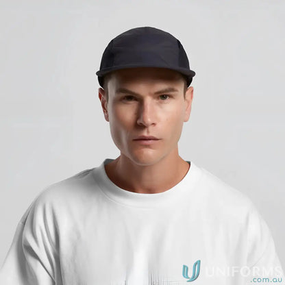 Man wearing dark blue recycled nylon Colour Active Finn Cap with white t-shirt