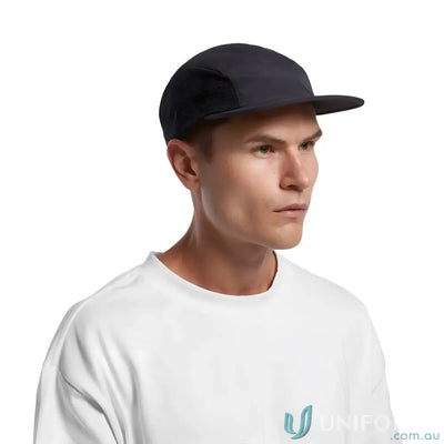 Man wearing black Colour Active Finn Cap made of recycled nylon and white tee