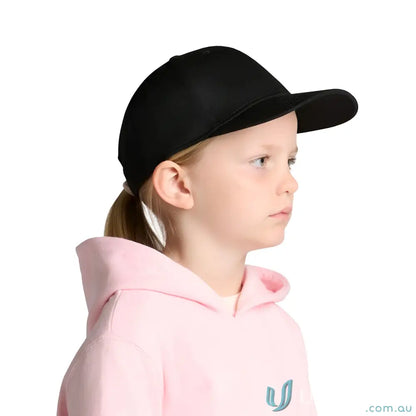 Young girl wearing a black mid profile Icon Kids Cap and pink hoodie