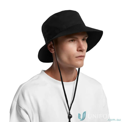 Person wearing AS Colour wide brim bucket hat with adjustable chin strap