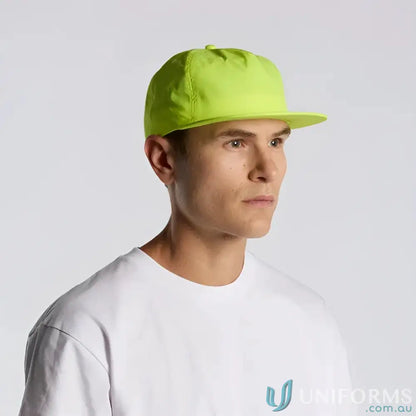 Man wearing neon green recycled nylon Colour Surf Safety Cap and white T-shirt