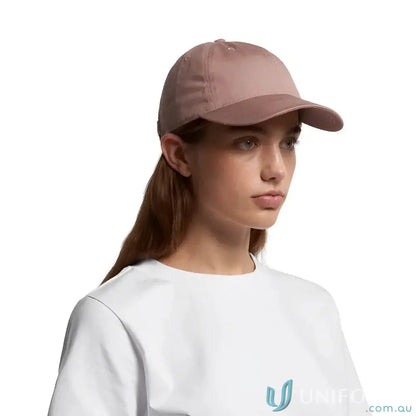 Woman wearing dusty pink AS Colour Women’s Access Cap with tonal under-peak lining
