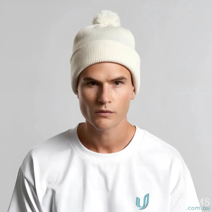 Cream-colored AS Colour Pom Pom Beanie with recycled acrylic and fluffy colour pom pom