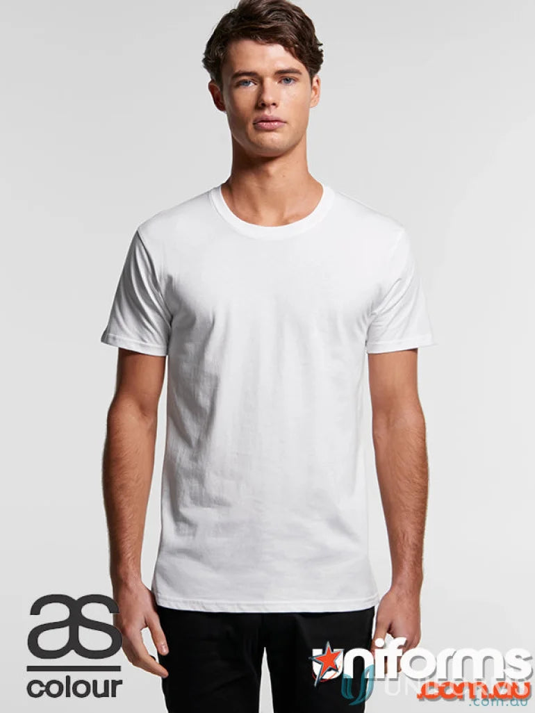 Young man modeling the AS Staple Organic Tee in white with black pants for a casual look