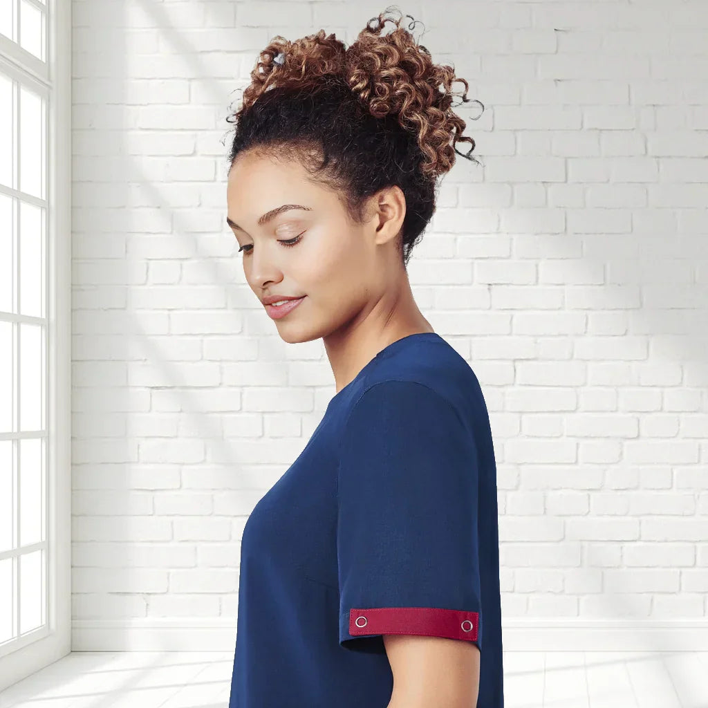 Navy blue unisex Avery scrub identifier top with red cuffs, hidden press studs