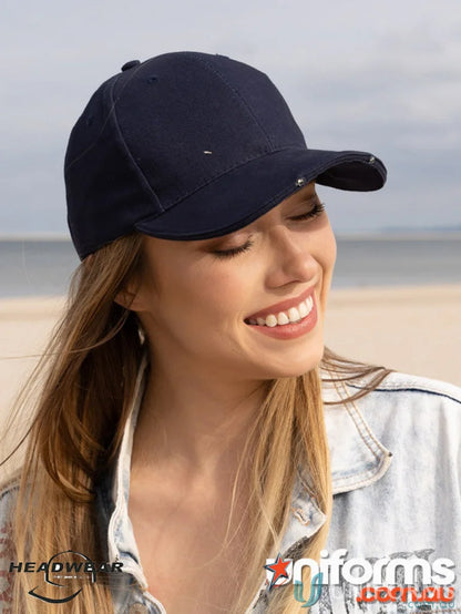 Woman in denim jacket and dark blue cap with LED lights in BHC workwear uniform