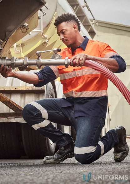 Man in bio motion taped stretch workwear jeans connecting a hose to a tanker