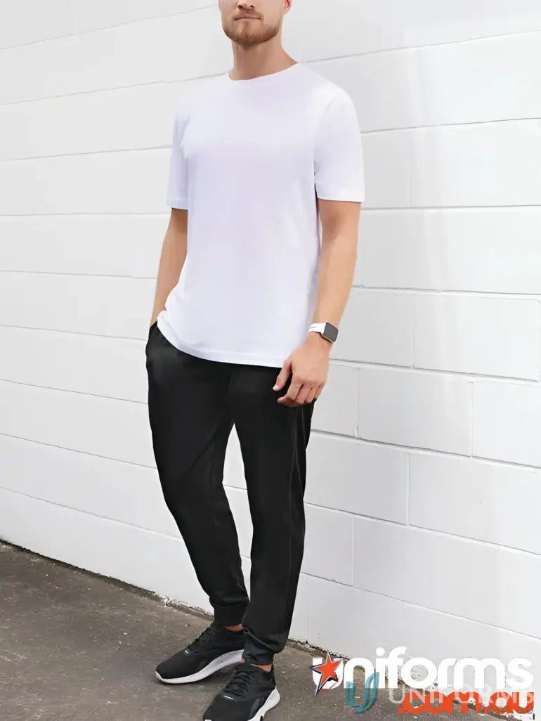 Man wearing Biz Collection Score Pant TP226M in white t-shirt and black pants