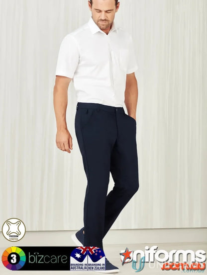 Man wearing Biz Comfort Waist Flat Front Pant in white shirt and dark blue pants