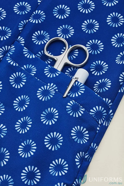 Blue patterned scrub top with pocket contents, Bizcare Women’s Daisy Print Tunic easy stretch daisy