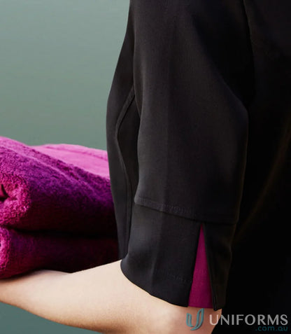 Folded purple towels for women’s Bliss Tunic made with stretch fabric and stain release