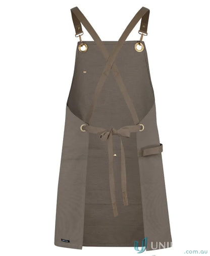 Brown eyelet canvas apron with criss-cross back straps and waist ties for the ultimate canvas apron look