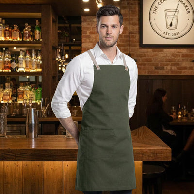 Brunswick bib apron in olive green with tan leather straps and front pocket