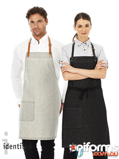 Two people showing off styles of Byron Indigo Apron in indigo denim, perfect for uniforms or purchase separately