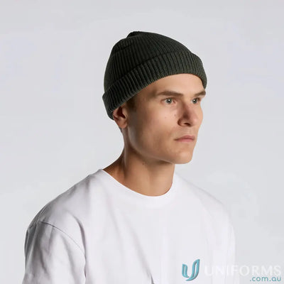 Man wearing dark green fisherman style AS Colour Cable Beanie 1120, mid-weight acrylic
