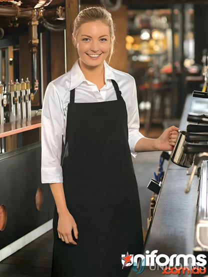Black ap03 bib apron with adjustable neck strap over white shirt for Winning Spirit Cafe