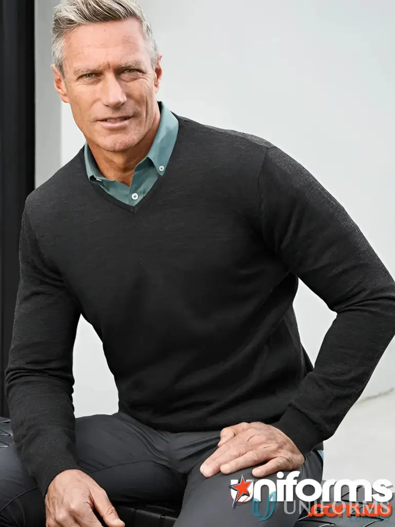 Man wearing dark V-neck sweater from Cann Compounding EMB Mens LS Pullover in ROMA KNIT collection