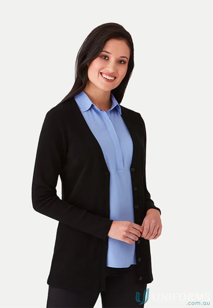 Woman’s black City Overknit cardigan in Australian Merino Wool over blue blouse, versatile neckline perfect for corporate wardrobe