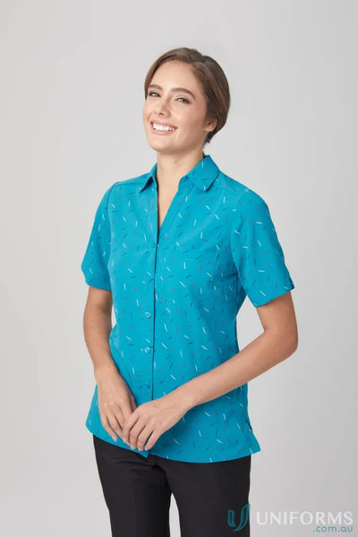 Woman in City Stretch Drift Print Tunic with blue pattern and black pants