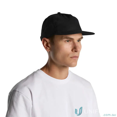 Man in black flat-brimmed Class Linen Cap with adjustable fastener and tonal under-peak lining